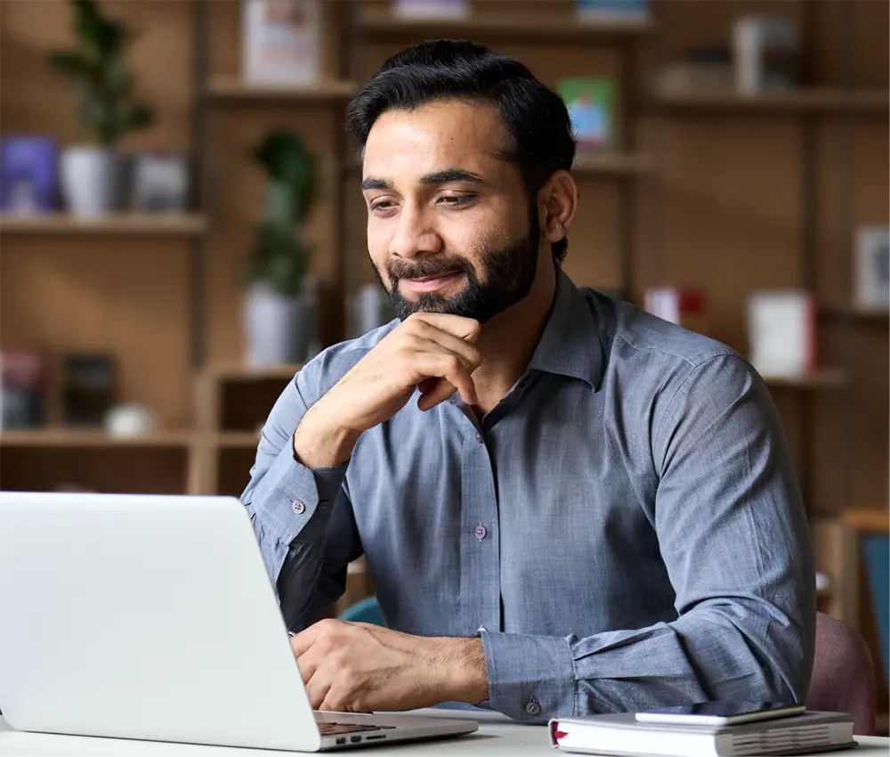 man smiling at computer