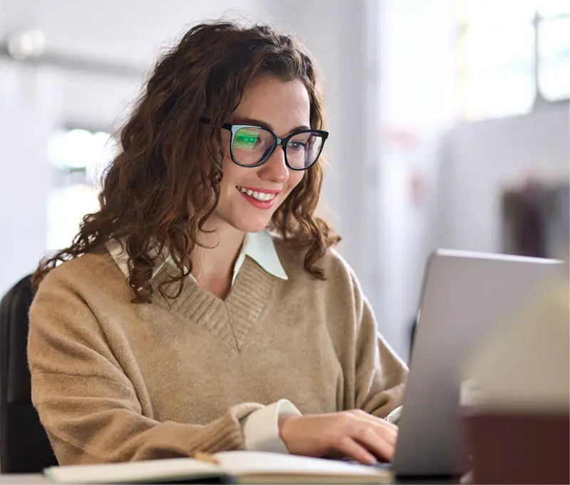 woman smiling at computer